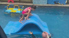 Child climbing over the foam pool waterslide